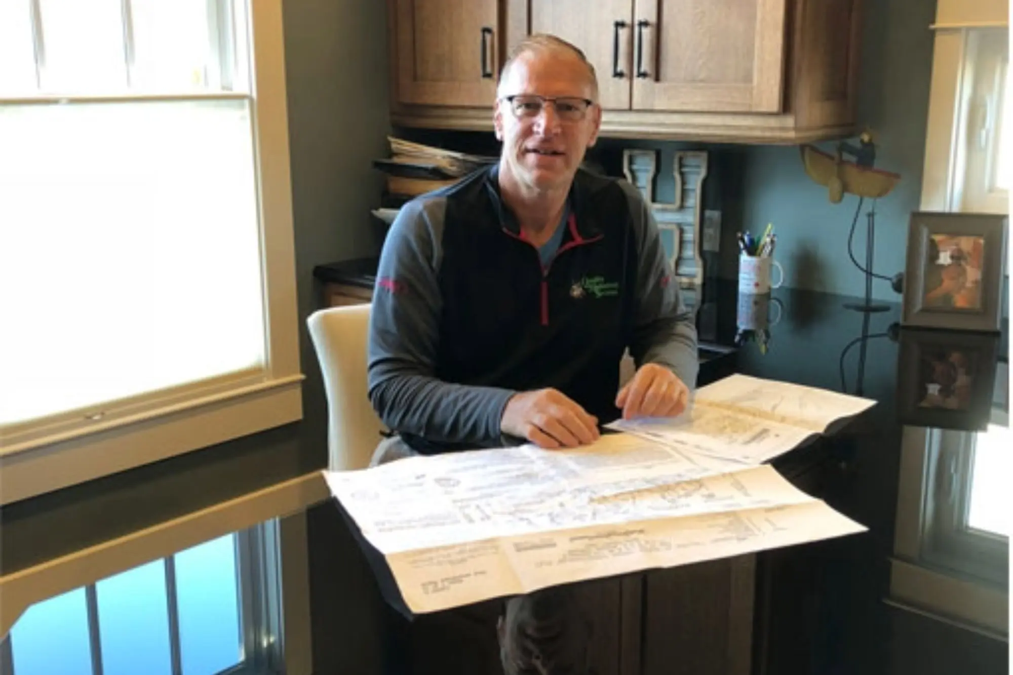 President of Quality Mechanical Services sitting at his desk